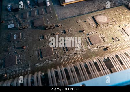 A detailed close-up view of a computer circuit board showing various microchips, integrated circuits, wiring, and electronic components used in modern Stock Photo
