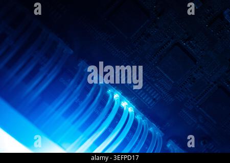 This image showcases a close-up view of data cables connected to a circuit board, highlighting modern electronic infrastructure and digital communicat Stock Photo