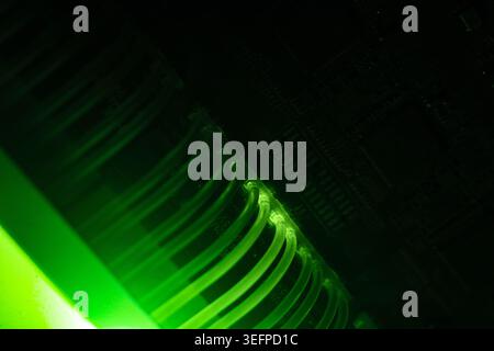 The image showcases a close-up view of a data storage device featuring illuminated green lights, highlighting advanced server hardware and electronic Stock Photo