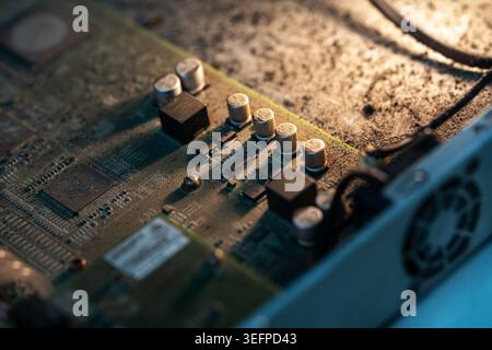 Detailed close-up of a computer circuit board showing various electronic components such as chips, capacitors, and power connectors, with a focus on h Stock Photo
