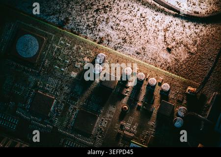 A detailed close-up image showing various electronic circuit board components such as chips, microprocessors, capacitors, and resistors on a printed c Stock Photo