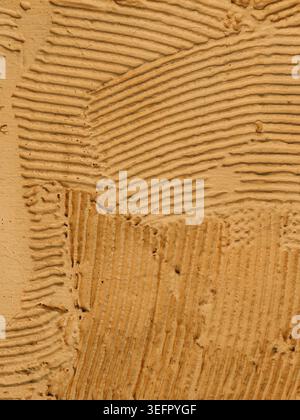 Abstract beige plaster texture with visible trowel marks, rough wall surface pattern for minimalist architectural background and copy space Stock Photo