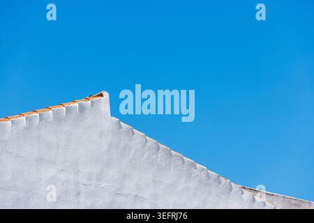 Blue Sky and White Painted House Wall Background Texture. Stock Photo