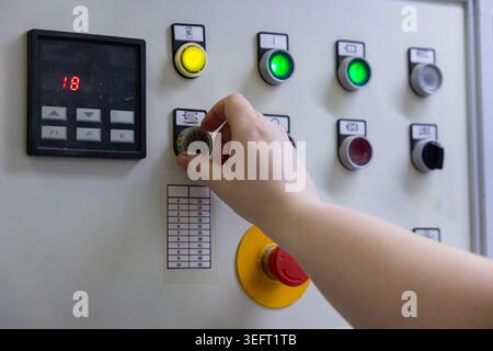Operator Adjusting Industrial Machine Control Panel Stock Photo