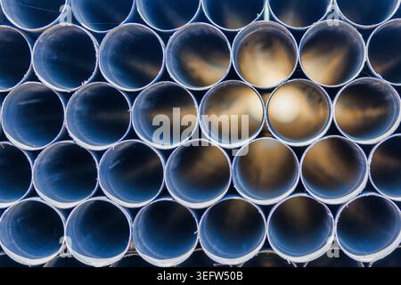 Abstract Stack of Pipes with Light at the End, Futuristic Tunnel Background. Stock Photo