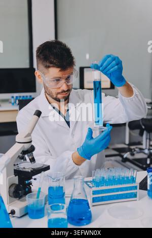 Lab technician experimenting in lab Stock Photo