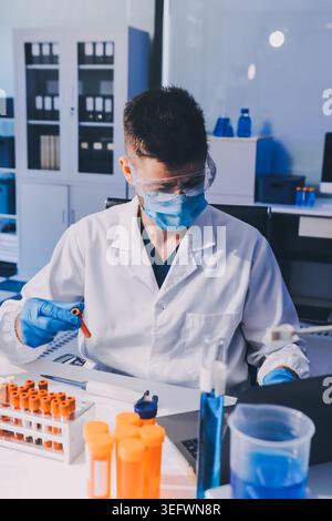 Lab technician experimenting in lab Stock Photo