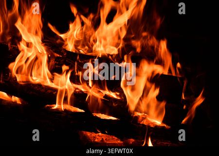 Fire embers particles over black background. Fire sparks background. Abstract dark glitter fire particles lights. Stock Photo