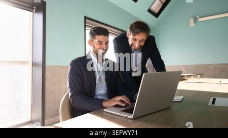 Colleagues working on laptop engage in project management in office Stock Photo