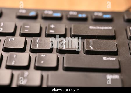 Angled Top View Macro Close-Up Black Computer Keyboard Highlighting Closing Bracket ] and Curly Brace } Keys on Blurred Tech Backgrounds Stock Photo