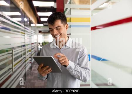Smiling businessman working online using digital tablet Stock Photo