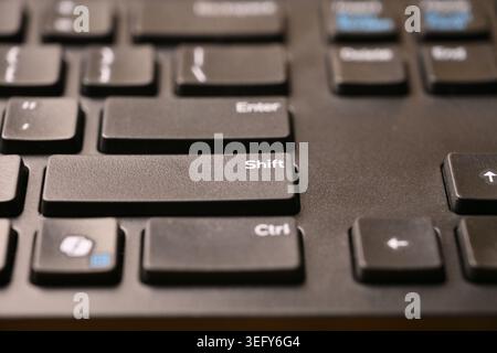 Black Computer Keyboard Macro Shot Highlighting Shift Key with Soft Blurred Backgrounds Angled Top View Stock Photo