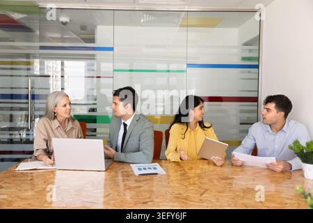 Group of businesspeople engaged in discussion in office Stock Photo