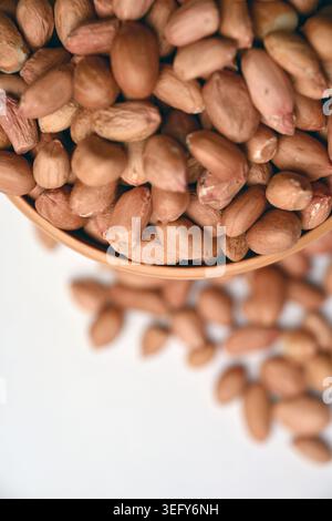 Peanuts in Bowl Top View with Defocus Background Macro Photography Stock Photo