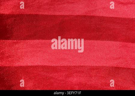 Red satin fabric background texture with horizontal shiny woven stripes Stock Photo
