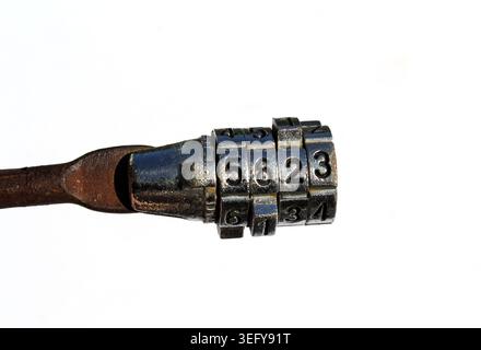 A close-up of a rusty metal combination bike lock with numbers on a plain white background Stock Photo