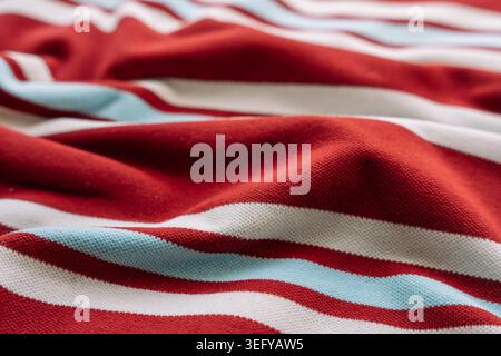 Red blue and white striped fabric with folds Stock Photo
