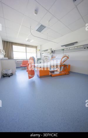 A spacious hospital room with an orange maternity bed and large windows, delivery room of the new gyn and obstetrics ward of the Klinikverbund Suedwes Stock Photo