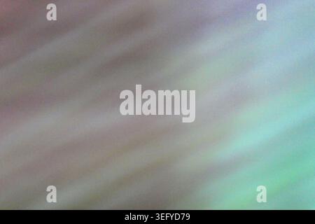 Abstract pastel background with diagonal motion blur and subtle film grain, blending lavender, pink, cyan, and teal tones for a dreamy, iridescent gra Stock Photo