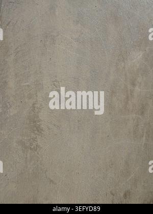 Macro of rough concrete surface with gray and beige mottling, granular speckles, and subtle imperfections, ideal as an abstract industrial background Stock Photo