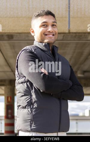 Portrait of latin entrepreneur in formal suit with crossed arms outdoors. Young man in formal wear arms crossed outdoors Stock Photo
