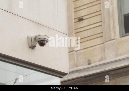 Security camera mounted on a building in a city area Stock Photo