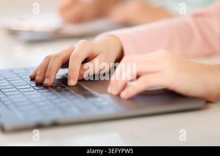 A close up view of a persons hands using a modern laptop keyboard ideal for themes of remote work education and digital communication. Stock Photo