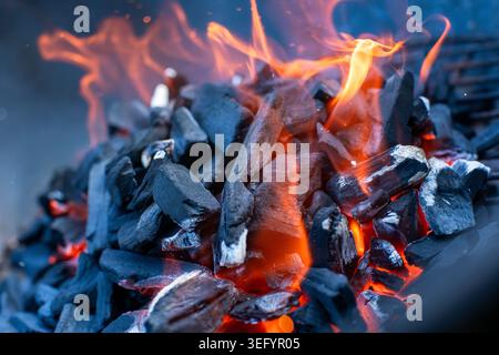 Dynamic Summer Barbecue Fire Close-Up, Glowing Coals with Flames Stock Photo