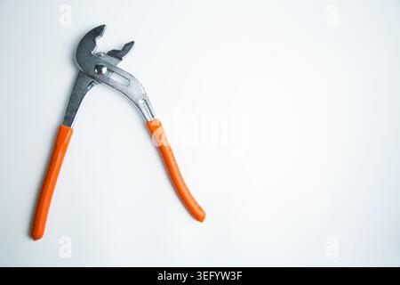 Close-up of an adjustable large wrench lies on a white background on the side with space for text Stock Photo