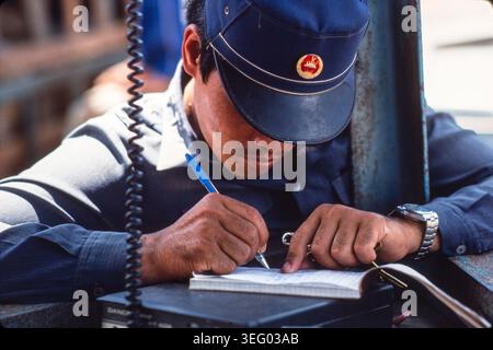 Traffic policemen making notes,  Phnom Penh, 1987 Stock Photo