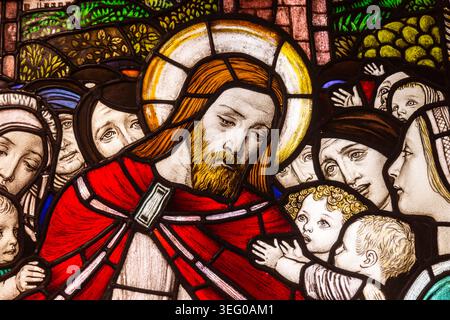Close up of stained glass window showing Christ with children, UK Stock Photo