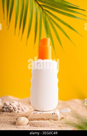 Sunblock or sunscreen in cosmetic tube on beach sand and beige background. Summer vacation and skin care concept with starfish and sea shells, spf uv-protect cosmetics. Skin health. High quality photo Stock Photo