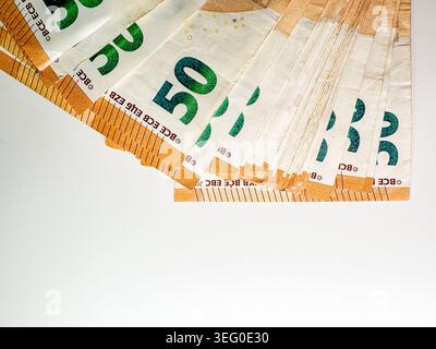 Cash displayed on white surface showing various denominations and designs of currency bills during daytime Stock Photo
