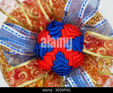 Close up of a traditional Roscon de Reyes Spanish cake decorated with colorful candied fruits and a large red blue ribbon for Epiphany holidays Stock Photo