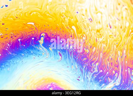 Close-up view of soap film interference colors creating a dynamic, fluid, and colorful abstract background Stock Photo