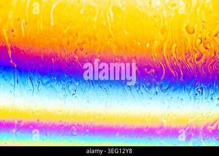 Close-up view of iridescent soap bubble surface displaying interference patterns and flowing colors Stock Photo
