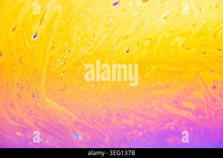 Abstract macro view of a soap film's interference colors, showcasing fluid dynamics and light refraction in a mesmerizing display Stock Photo