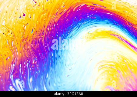 Macro view of swirling rainbow colors and patterns on a soap film, showcasing interference patterns and light refraction Stock Photo