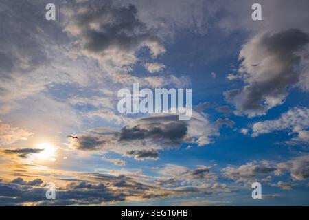 Sun in the sky at sunset, cloudscape natural background. Stock Photo