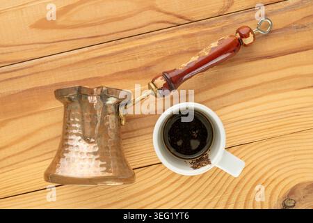 Copper coffee pot on a wooden table, close-up. Top view. Stock Photo