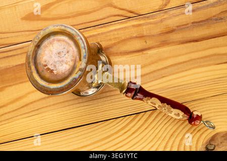 Copper coffee pot on a wooden table, close-up. Top view. Stock Photo