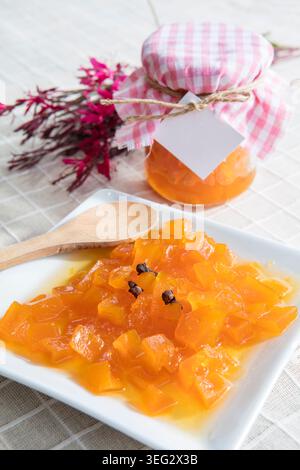 Pumpkin Jam Served on a Plate, Traditional Sweet Preserve with Tender Pumpkin Pieces, Rich Orange Color and Homemade Dessert Appearance Stock Photo