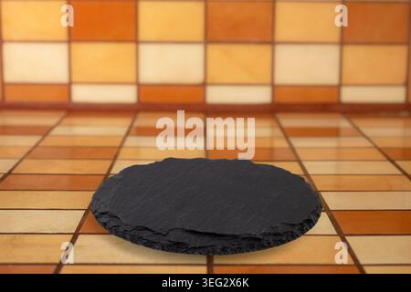 Round black stone slab on Rectangular ceramic tiles counter and backsplash mockup, soft focus perspective close up, empty design Stock Photo