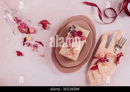 Process of decorating festive autumn table setting with dried flowers Stock Photo