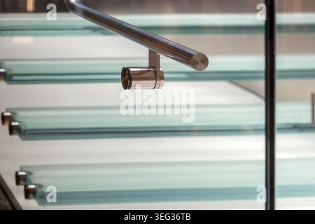Modern interior design detail featuring chrome railing and high-tech glass steps Stock Photo