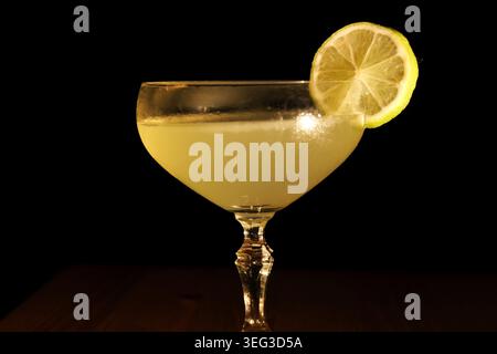 Refreshing margarita cocktail made with tequila, lime juice, and orange liqueur, served in a vintage coupe glass and garnished with a fresh lime slice Stock Photo