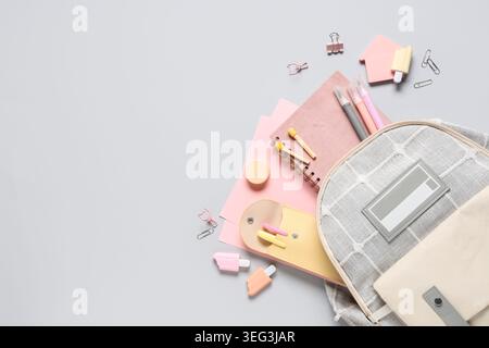Stylish school backpack and different stationery on grey background Stock Photo