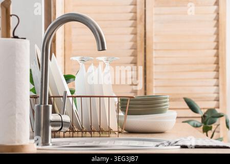Sink and clean dishes on counter in kitchen Stock Photo