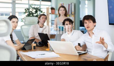 Group of colleagues watching presentation in office Stock Photo