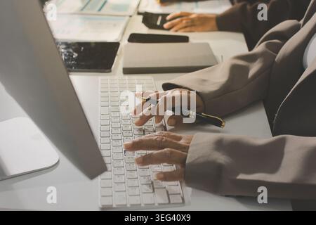 Two young Asian businesswomen discuss investment project working and ...